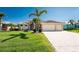 Well maintained front yard and beautiful facade for great curb appeal at 15762 Aqua Cir, Port Charlotte, FL 33981