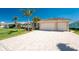 Well-manicured lawn leads up to this beautiful home with a large garage at 15762 Aqua Cir, Port Charlotte, FL 33981