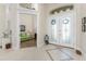 Inviting foyer with tile floors, high ceilings, and an open view to the formal living room, creating a welcoming ambiance at 15762 Aqua Cir, Port Charlotte, FL 33981