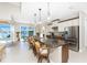 Eat-in kitchen boasts a center island, granite counters, pendant lighting and waterfront views from the sliding doors at 15762 Aqua Cir, Port Charlotte, FL 33981