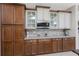 Kitchen with wood cabinets, stainless appliances, granite countertops, tile backsplash and glass front cabinets at 15762 Aqua Cir, Port Charlotte, FL 33981