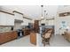 Stylish kitchen with two-tone cabinets, granite countertops, a breakfast bar, and stainless steel appliances at 15762 Aqua Cir, Port Charlotte, FL 33981