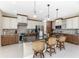 Well-equipped kitchen featuring an island with seating, two-tone cabinetry, and modern stainless steel appliances at 15762 Aqua Cir, Port Charlotte, FL 33981