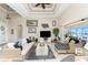Comfortable living room with tray ceilings, wicker sofas, and waterfront views from the large sliding glass door at 15762 Aqua Cir, Port Charlotte, FL 33981