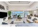 Spacious living room with wicker sofas and a large sliding glass door leading to the outdoor screened in patio at 15762 Aqua Cir, Port Charlotte, FL 33981