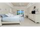 Spacious main bedroom with tray ceiling, waterfront view, and dresser at 15762 Aqua Cir, Port Charlotte, FL 33981