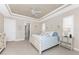 Bright main bedroom features a tray ceiling, ceiling fan, and ensuite bathroom access at 15762 Aqua Cir, Port Charlotte, FL 33981