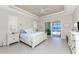 Spacious main bedroom with a ceiling fan, waterfront view, and patio access at 15762 Aqua Cir, Port Charlotte, FL 33981