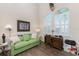 Office with hardwood flooring, a green couch, zebra accents, and shuttered windows at 15762 Aqua Cir, Port Charlotte, FL 33981