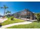 View of screened in back patio featuring a pool and lush landscaping at 15762 Aqua Cir, Port Charlotte, FL 33981