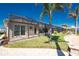 Screened in back patio with stone floors overlooks lush landscaping and green grass at 15762 Aqua Cir, Port Charlotte, FL 33981
