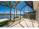 The screened-in patio features a waterfront view of the canal, as well as a view of the pool at 15762 Aqua Cir, Port Charlotte, FL 33981
