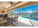 Outdoor living area with a pool, screened-in patio, and waterfront views at 15762 Aqua Cir, Port Charlotte, FL 33981