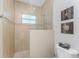 Bathroom shower features tile surround, glass partition, and a window at 15762 Aqua Cir, Port Charlotte, FL 33981