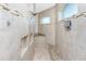 Modern shower showcasing tiled walls, niche storage, and sleek showerhead at 15762 Aqua Cir, Port Charlotte, FL 33981