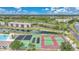 Aerial view of tennis courts, the pool, and the surrounding community at 175 Kings Hwy # 226, Punta Gorda, FL 33983
