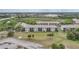 Aerial view of condominiums with grassy areas, lakes, and parking areas surrounding buildings at 175 Kings Hwy # 226, Punta Gorda, FL 33983