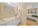 Bathroom with white vanity, plenty of lighting, and access to the bedroom at 175 Kings Hwy # 226, Punta Gorda, FL 33983