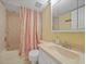 Bathroom with a shower and tub combo, vanity, and soft colored walls at 175 Kings Hwy # 226, Punta Gorda, FL 33983