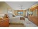 Bedroom with ceiling fan, dresser, and balcony access at 175 Kings Hwy # 226, Punta Gorda, FL 33983