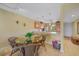 Dining area with glass table and wicker chairs, open to kitchen with tile flooring at 175 Kings Hwy # 226, Punta Gorda, FL 33983
