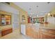 View of the kitchen flowing into living space, featuring wood cabinets and tile flooring at 175 Kings Hwy # 226, Punta Gorda, FL 33983