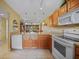 Kitchen with open floor plan flowing to living area, featuring light wood cabinets and tile floors at 175 Kings Hwy # 226, Punta Gorda, FL 33983