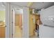 Laundry area with washer, dryer, shelving, and adjacent bathroom at 175 Kings Hwy # 226, Punta Gorda, FL 33983