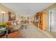 Open-concept living room with view to the kitchen, comfortable seating, and lots of natural light at 175 Kings Hwy # 226, Punta Gorda, FL 33983