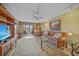 Comfortable living room with ceiling fan, sofa, and balcony access at 175 Kings Hwy # 226, Punta Gorda, FL 33983