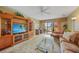 Inviting living room with ceiling fan, comfortable seating, and sliding glass doors to the balcony at 175 Kings Hwy # 226, Punta Gorda, FL 33983
