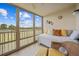 Bright sunroom with a bed and a view of the scenery at 175 Kings Hwy # 226, Punta Gorda, FL 33983