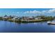 Aerial view of waterfront homes along a canal with boat docks at 18106 Petoskey Cir, Port Charlotte, FL 33948