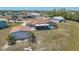 Aerial view of a single-Gathering home featuring a screened-in pool and spacious backyard at 18106 Petoskey Cir, Port Charlotte, FL 33948