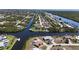 An aerial view of waterfront homes along a serene canal in a residential neighborhood at 18106 Petoskey Cir, Port Charlotte, FL 33948