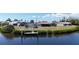 Waterfront property with a private dock, lush greenery, and tranquil views at 18106 Petoskey Cir, Port Charlotte, FL 33948