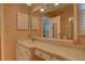 Bright bathroom with a vanity, sink, and a large mirror, with a view into another room at 18106 Petoskey Cir, Port Charlotte, FL 33948