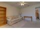 Bright carpeted bedroom with ceiling fan, sofa, and side table at 18106 Petoskey Cir, Port Charlotte, FL 33948