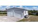 Exterior view of a two-car garage with white siding and concrete driveway at 18106 Petoskey Cir, Port Charlotte, FL 33948