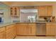Well-lit kitchen offers plenty of counter space, stainless dishwasher, and bright cabinets at 18106 Petoskey Cir, Port Charlotte, FL 33948
