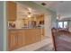 An open kitchen features a ceiling fan and view into the dining room at 18106 Petoskey Cir, Port Charlotte, FL 33948