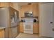 Spacious kitchen with stainless steel refrigerator, microwave, and lots of cabinet space at 18106 Petoskey Cir, Port Charlotte, FL 33948