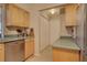 Bright kitchen includes a stainless steel dishwasher, lots of cabinets, and a view of the pantry at 18106 Petoskey Cir, Port Charlotte, FL 33948