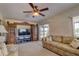 Living room features neutral paint, carpet, a sliding glass door, and a ceiling fan at 18106 Petoskey Cir, Port Charlotte, FL 33948
