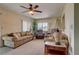 Bright living room features carpet floors, neutral paint, and a ceiling fan at 18106 Petoskey Cir, Port Charlotte, FL 33948