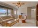 Bright living room with neutral tile flooring, plush seating, and large window at 18106 Petoskey Cir, Port Charlotte, FL 33948