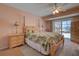Cozy main bedroom with a floral-patterned bedspread and access to the pool area at 18106 Petoskey Cir, Port Charlotte, FL 33948