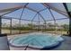 Enclosed backyard spa with see-through screen enclosure at 18106 Petoskey Cir, Port Charlotte, FL 33948