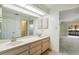 Bathroom featuring double sinks, large mirror, and ample cabinet storage at 2192 Hyatt Dr, Port Charlotte, FL 33948