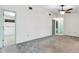 A spacious bedroom with a ceiling fan, carpet flooring, and doors leading to other rooms at 2192 Hyatt Dr, Port Charlotte, FL 33948